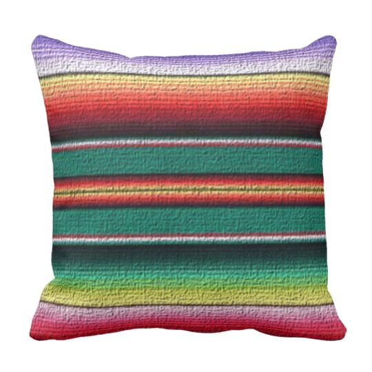 a multicolored striped pillow on a white background