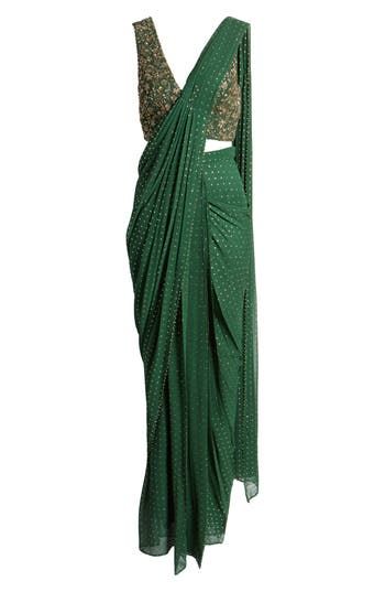 This saree has a hand-embroidered cropped top with intricate beadwork and lustrous sequins and is paired with a skirt featuring attached wraparound draping. Hidden side-zip closure V-neck Sleeveless Lined 100% viscose Spot clean Imported Asian & Pacific Islander Owned/Founded Traditional Embellished Pre-draped Saree For Festive Season, Designer Wear Draped Dupatta With Mirror Work, Designer Draped Dupatta With Mirror Work, Designer Mirror Work Draped Dupatta, Traditional Draped Sequin Dress, Green Pre-draped Saree For Reception, Festive Draped Sequin Dupatta, Green Blouse Piece For Evening With Traditional Drape, Green Draped Lehenga With Cutdana