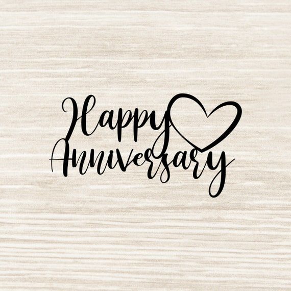 the words happy anniversary written in black ink on a white background with a wooden surface