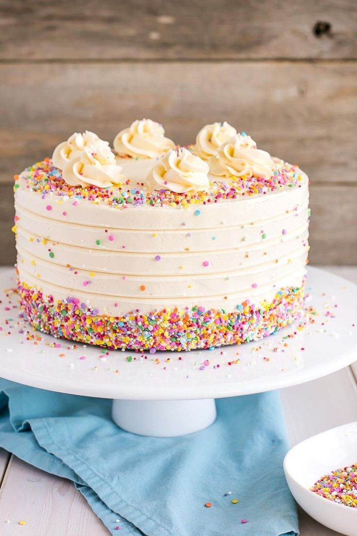 a cake with sprinkles and white frosting