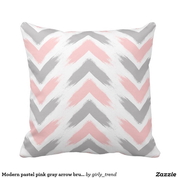 a gray and pink pillow with white trim