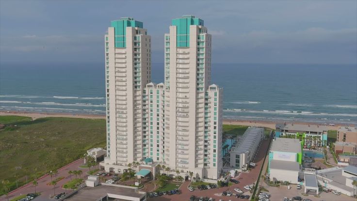 two high rise buildings next to the ocean