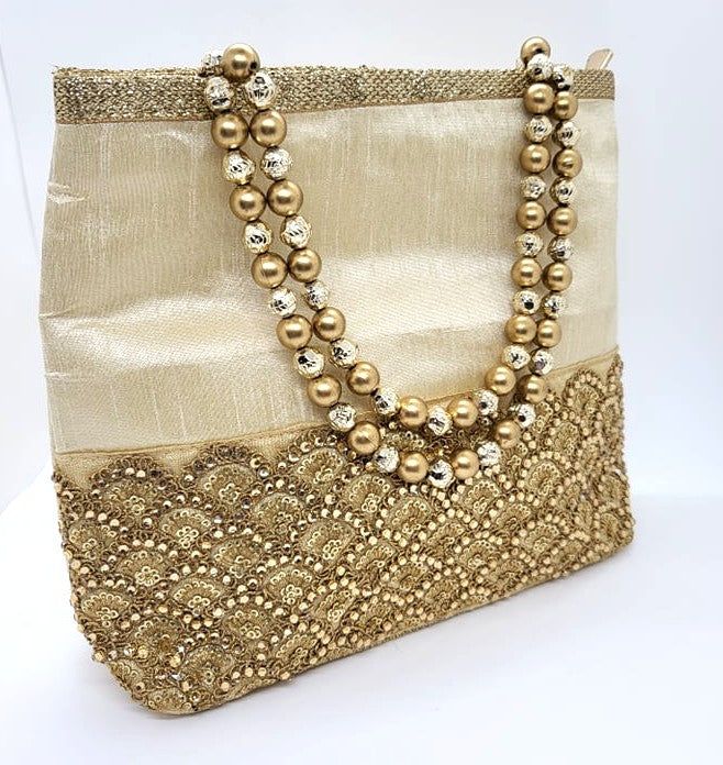 Product Description Raw silk handbags with Golden Zari Gota Patti work on the front side A pocket with zipper on the backside Ideal or Housewarming, Wedding, and other festive occasions. Dimensions: 8.5" x 8.5" Weight: 6 Oz each Material: Raw silk fabric Actual color may slightly vary due to the screen resolution. Design: HBS#185 Festive Gold Shoulder Bag With Dori Work, Gold Evening Bag With Dori Work, Gold Shoulder Bag With Zari Work For Evening, Evening Gold Shoulder Bag With Zari Work, Elegant Bags With Handwork For Celebration, Elegant Festive Potli Gift Bag, Elegant Festive Gift Potli Bag, Elegant Gota Work Potli Bag For Party, Handwork Shoulder Bag For Celebrations