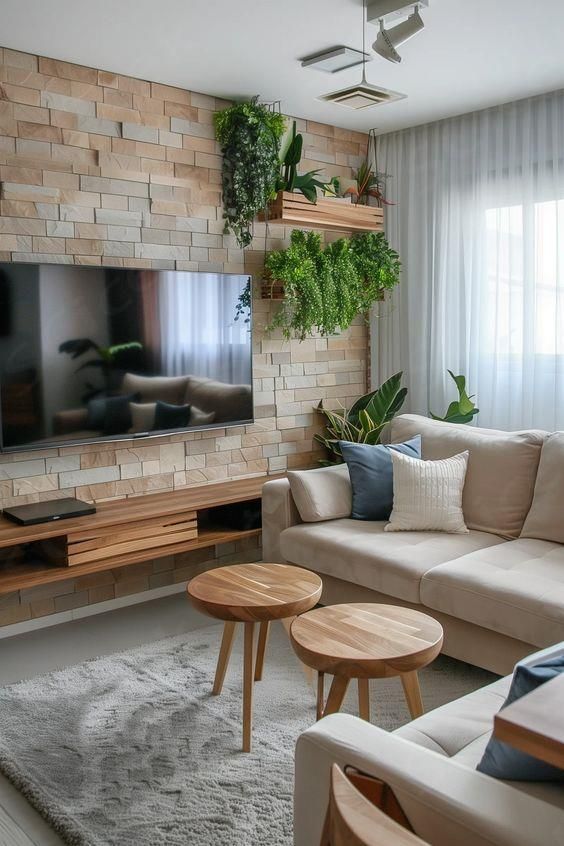 a living room filled with furniture and a flat screen tv mounted on a wall above a wooden coffee table