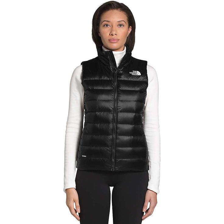 The North Face Women's Aconcagua Vest is a down and synthetic insulator for your core. Pop into town and forget about wearing the whole heavy jacket. The combination of 550 fill goose down in the body with 150g Heatseeker Eco at the sides allows warmth, low weight and a regular Fit without added bulk. Throw it overtop a base layer or button up long sleeve and go about your daily life. A nylon WindWall exterior fabric is not only wind-resistant, but has been treated with a durable water repellent Iridescent Fabric, North Face Vest, Vest Womens, Black Aviators, Vest Outfits, Down Vest, North Face Women, Womens Vest, North Face