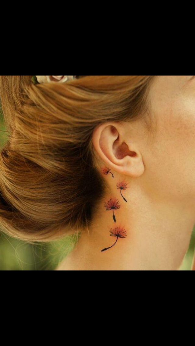 a woman's ear has a dandelion tattoo on it