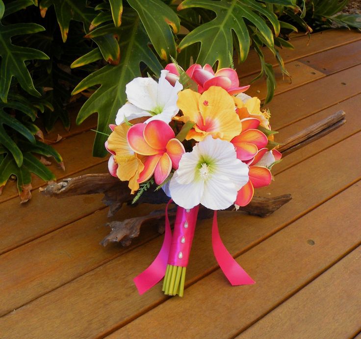 a bouquet of flowers sitting on top of a wooden bench