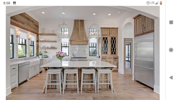 a large kitchen with an island in the middle