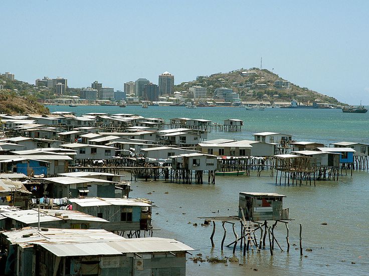 a bunch of houses that are sitting in the water next to each other on stilts