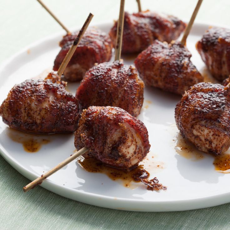 meatballs with toothpicks on a white plate