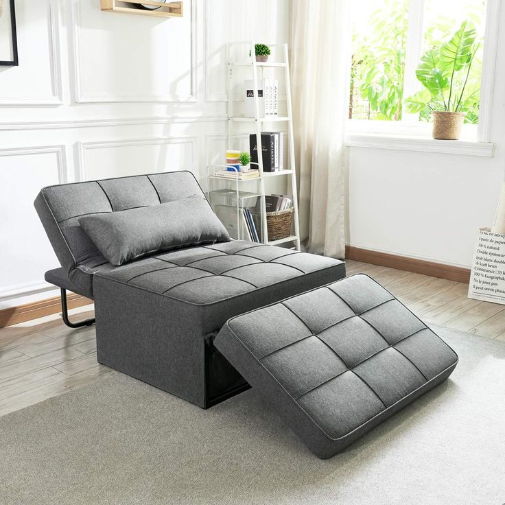 a gray recliner chair and ottoman in a living room