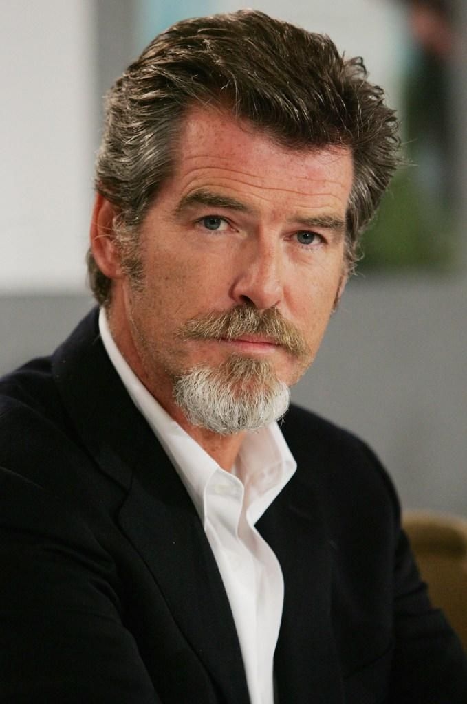 a close up of a person wearing a suit and tie with a white shirt on