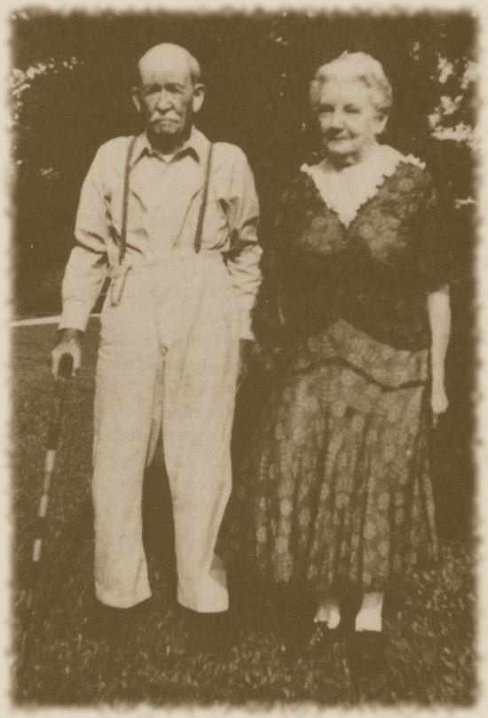 an old black and white photo of two people standing next to each other in the grass