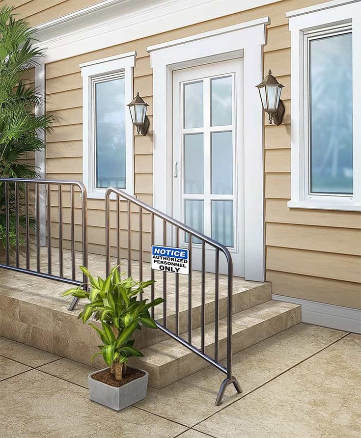 a potted plant sitting on the side of a metal hand rail next to a door