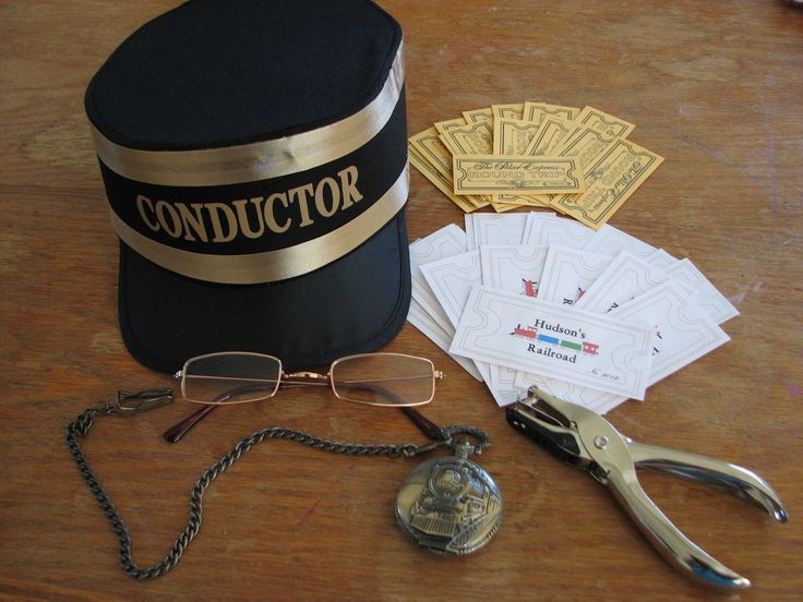 a hat, eyeglasses, and other items are sitting on a wooden table