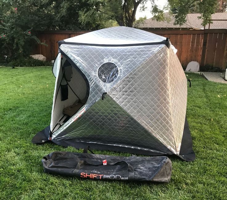 a tent that is sitting in the grass with its door open and it's cover opened