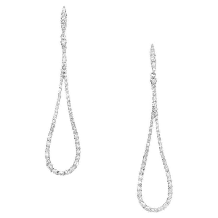 Elegant Loop shaped dangle diamond earrings. Comprised of 16 single cut diamonds totaling .90cts, set in 14k white gold loop style settings. 1.8 inches long diamond dangle drop earrings. Follow us on our 1stDibs storefront to view our weekly new additions and 5 Star Reviews at Peter Suchy Jewelers. 16 single cut diamonds, G-H SI approx. .90cts 14k white gold Stamped: 14k 3.6 grams Top to bottom: 46.0mm or 1.8 inch Width: 10.5mm or .41 Inches Depth or thickness: 1.9mm Luxury White Gold Long Drop Earrings, White Brilliant Cut Dangle Diamond Earrings, Luxury Diamond White Drop Linear Earrings, Luxury White Clip-on Diamond Earrings, Luxury White Diamond-cut Chandelier Earrings, Diamond Dangle Earrings, Gold Earrings Dangle, Vintage Earrings, Diamond White