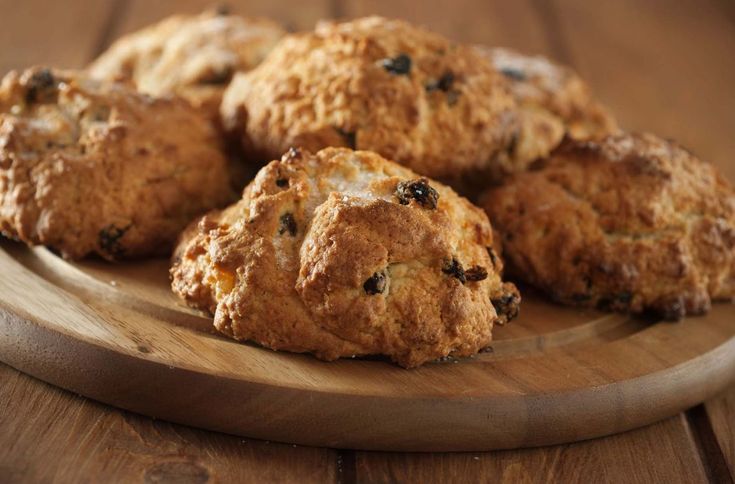 some biscuits are on a wooden plate and ready to be eaten