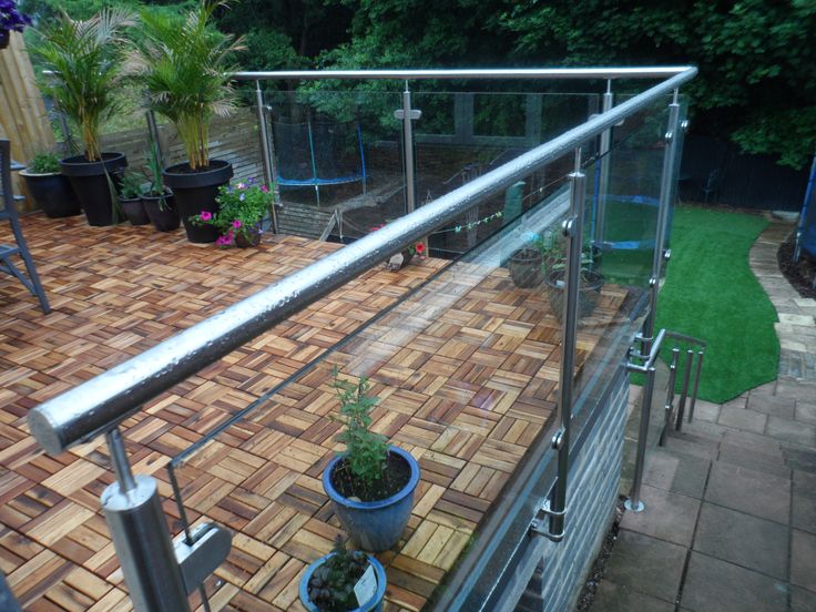 an outdoor deck with potted plants on it