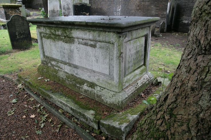 an old cemetery with moss growing on the ground