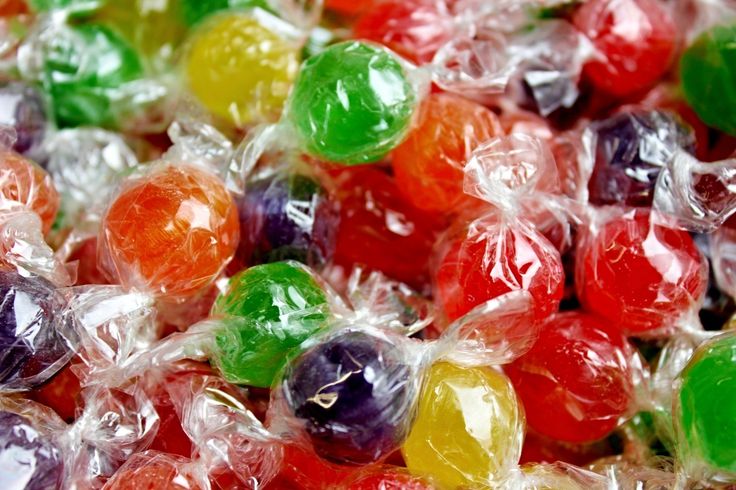 many different colored candies in plastic bags