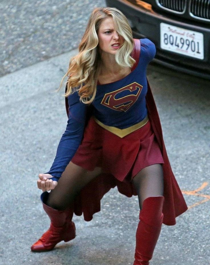 a woman dressed as a supergirl on the street