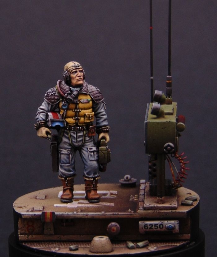 a figurine is standing on top of a tank with a machine in the background