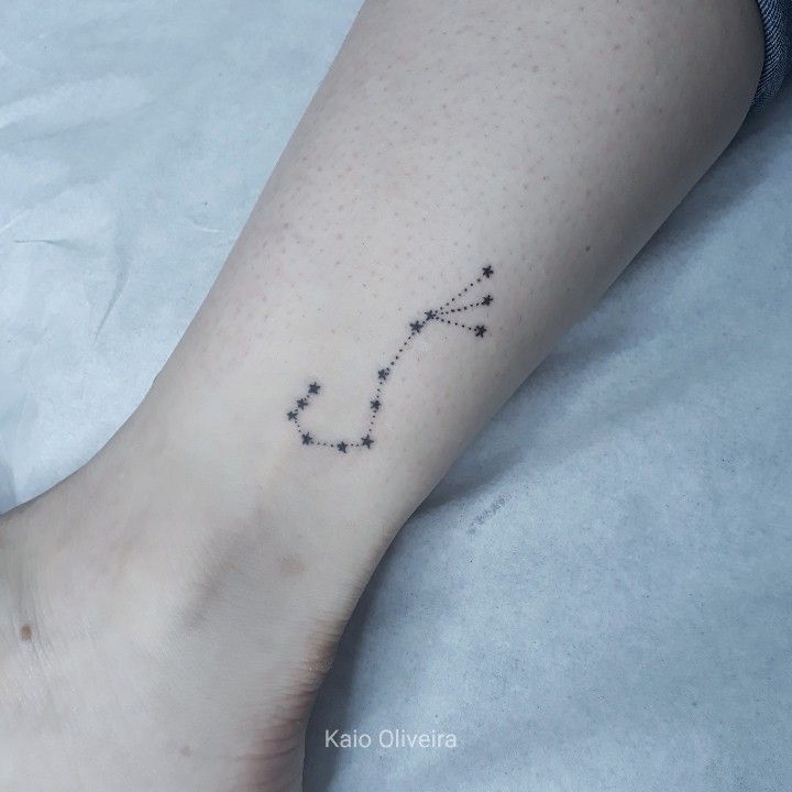 a woman's foot with a star tattoo on her left ankle and the word love written in small stars