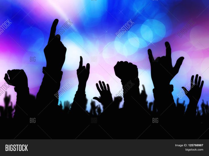 silhouettes of people raising their hands in the air at a concert or party with bright lights