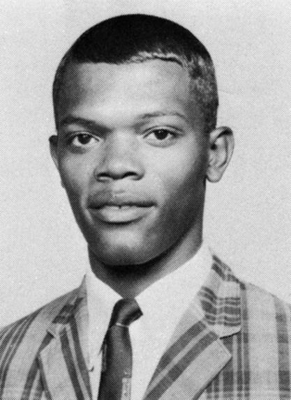 a black and white photo of a man in a suit