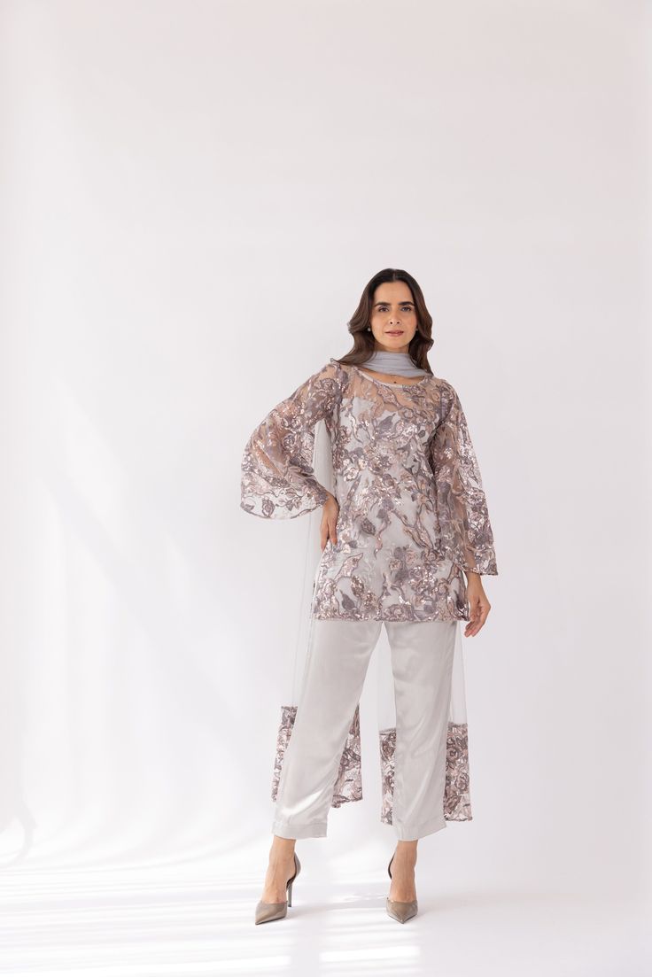 Featuring a silver embroidered boat neck kurta set in net base. It is paired with solid pants and net dupatta with sequin work. Color: SILVER FABRIC: NET Delivery time 15 to 20 days Semi-stitched Sequined Straight Kurta Set, Eid Party Pant Set With Straight Kurta, Designer Eid Pant Set With Dupatta, Party Eid Pant Set With Straight Kurta, Silver Semi-stitched Salwar Kameez For Festive Occasions, Silver Bollywood Salwar Kameez For Festive Occasions, Semi-stitched Designer Pant Set For Eid, Designer Georgette Pant Set For Eid, Designer Anarkali Silver Kurta