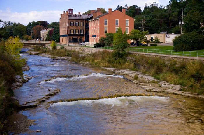 a river running through a lush green countryside