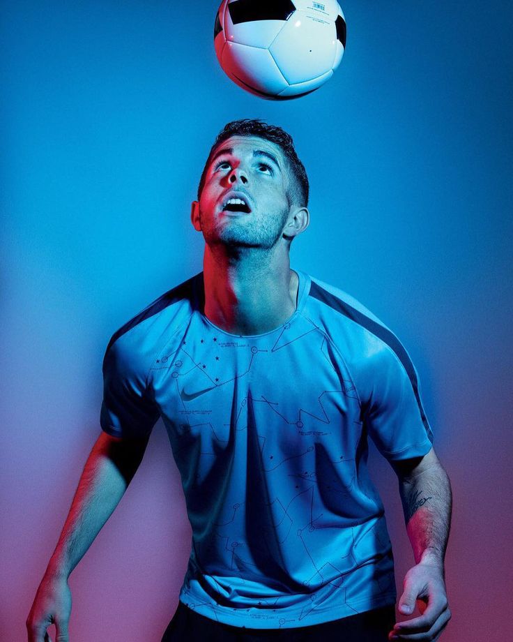 a man with his head in the air and a soccer ball above him, against a blue background