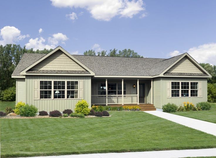 a small house sitting in the middle of a lush green field with lots of grass