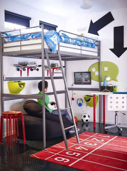 a boy is sitting on a bean bag chair in front of a bunk bed with a ladder