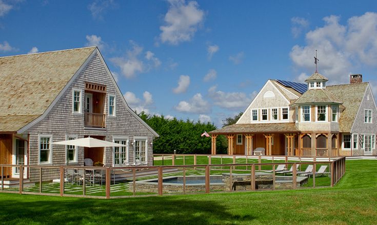 two large houses sitting on top of a lush green field