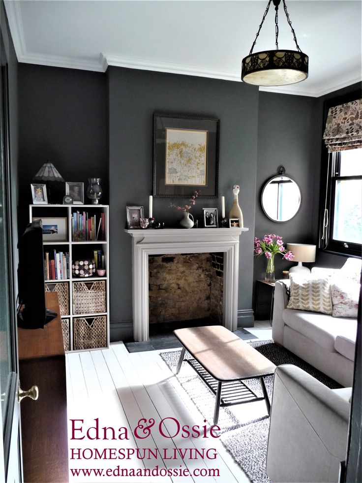 a living room filled with furniture and a fire place next to a white fireplace mantel