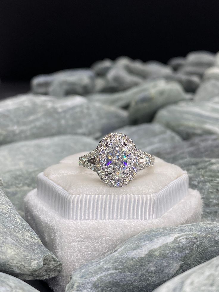 a diamond ring sitting on top of a rock