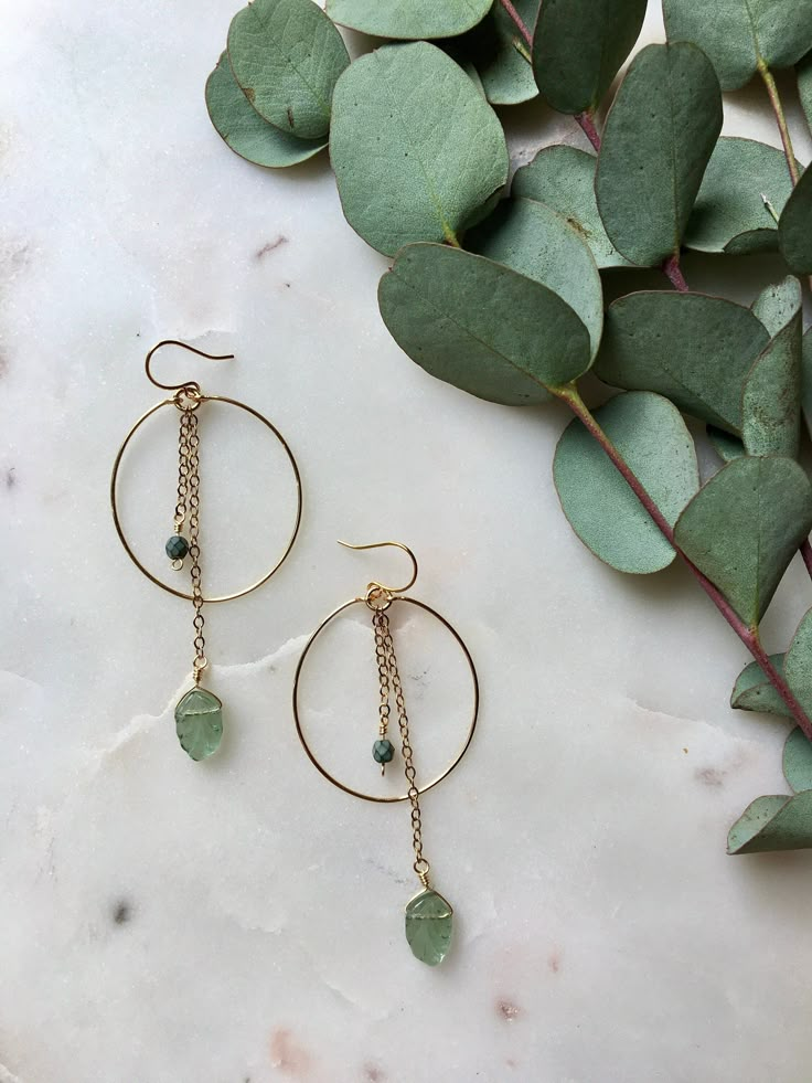 HOLIDAY ORDER DEADLINE: Orders placed after December 18 will not be shipped until January 3!  Clear aqua, green, or turquoise leaf chain dangles on a gold wire hoop. Including the ear wire, they are 3in long by 1 1/8in wide. Made with gold plated wire; wire wrapped detail to secure the hoop is attached to an elegant ear wire. If you have allergies that restrict which metals you can wear, please send me a message first before purchasing. Visit poppyjewelrydesigns.com for more inventory and new st Adjustable Green Hoop Jewelry, Green 14k Gold-filled Dangle Earrings, Green 14k Gold Filled Dangle Earrings, Bohemian Wire Dangle Jewelry, Green Bohemian Hoop Jewelry, Bohemian Green Hoop Jewelry, Green Dangle Hoop Earrings, Green Dangle Jewelry For Everyday Wear, Bohemian Green Wire Wrapped Hoop Earrings