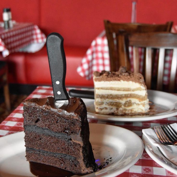 a slice of chocolate cake with a knife stuck in it