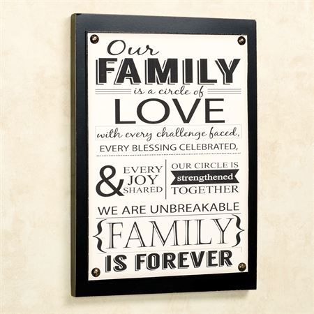 a black and white family is forever sign hanging on the wall in a room with striped walls