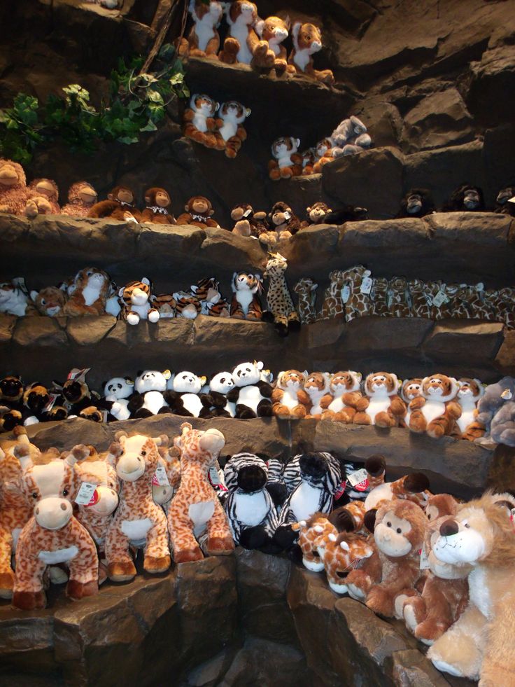 many stuffed animals are on display in a cave