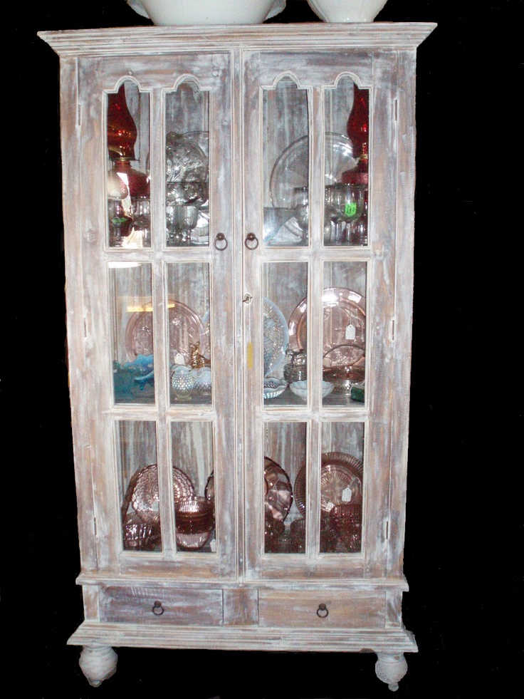 an old china cabinet with glass doors