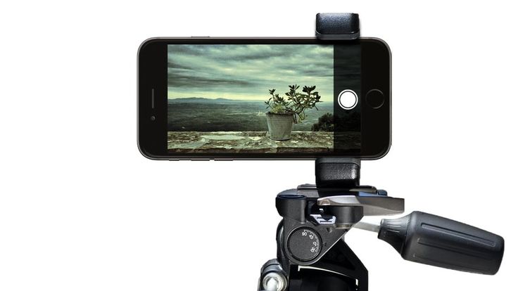 a cell phone is attached to a tripod with a camera on it's arm