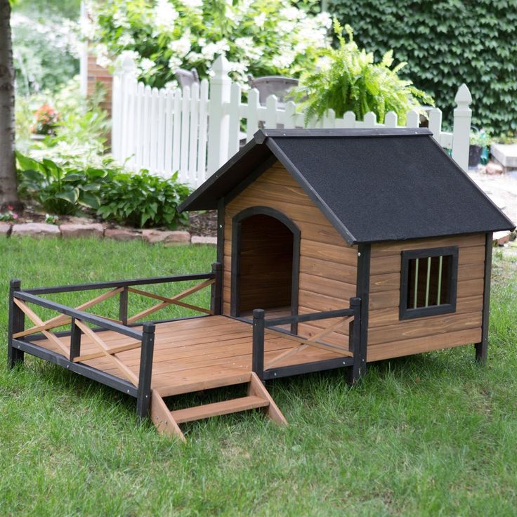 a wooden dog house with a ramp leading up to it