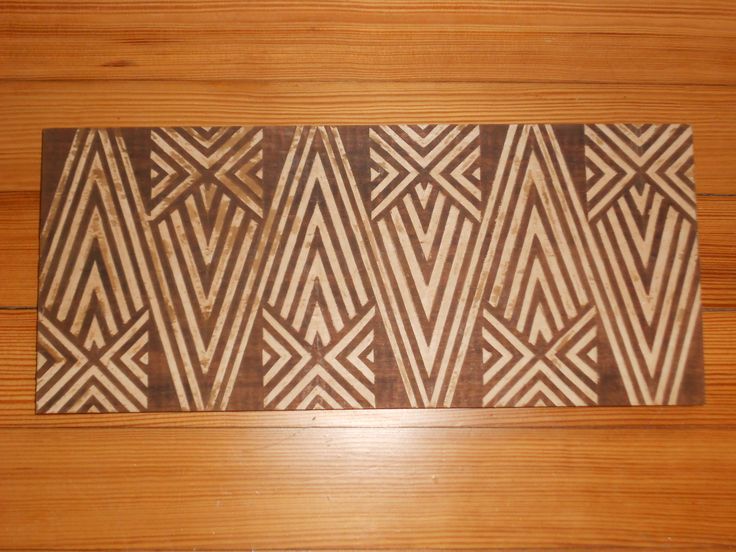 a brown and white area rug sitting on top of a wooden floor