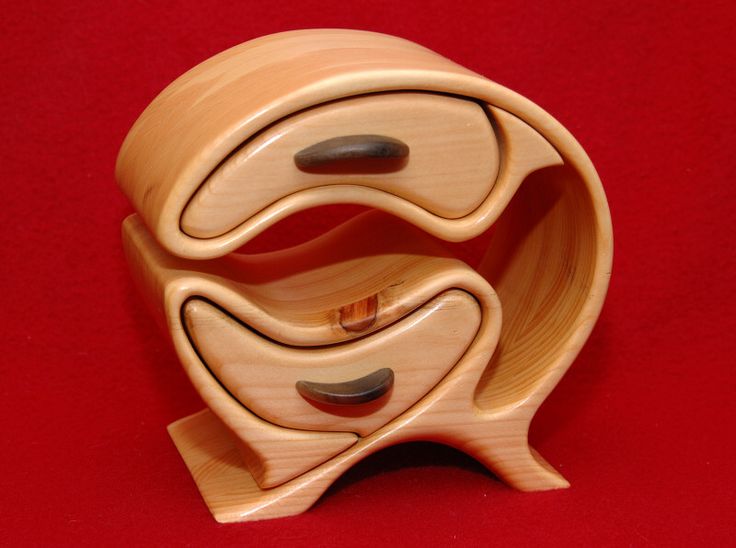 three wooden bowls stacked on top of each other, with one bowl in the middle