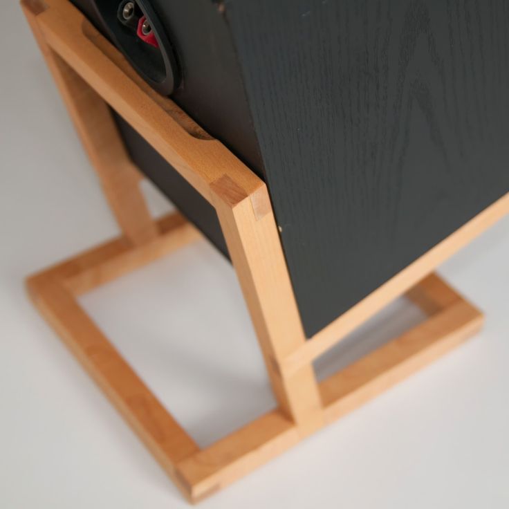 an electronic device sitting on top of a wooden stand