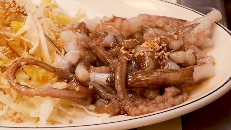 a white plate topped with meat and veggies