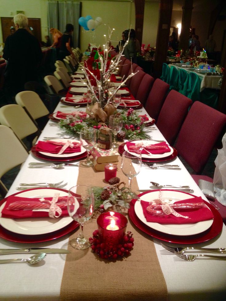 the table is set with red and white place settings